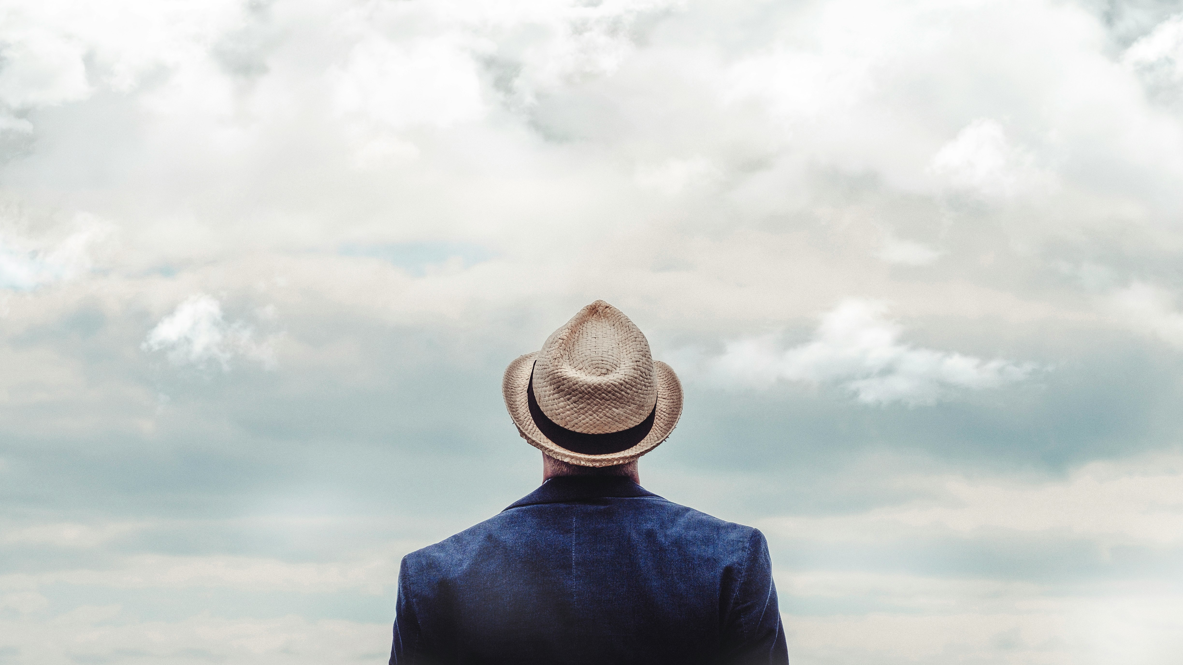 man standing under cloudy sky during daytime